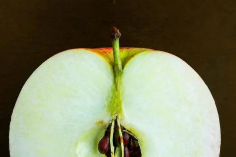 Sliced apple macro image on dark background. Close up of fresh ripe fruit wit Stock-Fotos