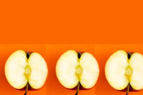 Sliced apple pattern on orange background, copy space for the text, banner Stockfoto's