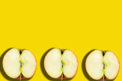 Sliced apple pattern on yellow background, copy space for the text, banner Stockfoto's