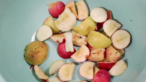 The sliced apple pieces fall into the basin. Stock Footage 159424120