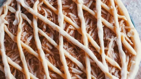 Sliced apples on cake batter in baking pan Stock Footage