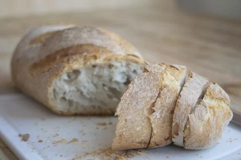 Sliced artisan bread on board Stock Photos