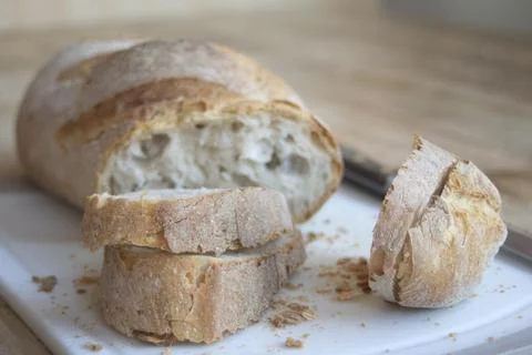 Sliced artisan bread on board Stock Photos