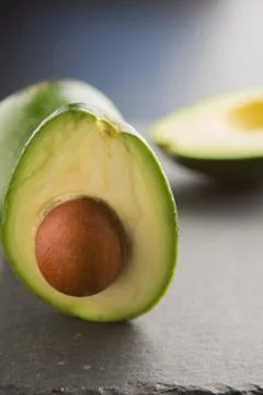 Sliced avocado on a dark background Stock Photos