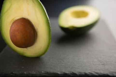 Sliced avocado on a dark background Stock Photos