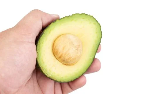 Sliced Avocado in the hand Stock Photos