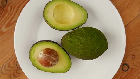 Sliced avocado on a plate. Video stock 238721976