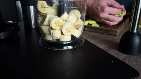 Sliced avocado slices are put in a blender to make smoothies Stock Footage 257307059