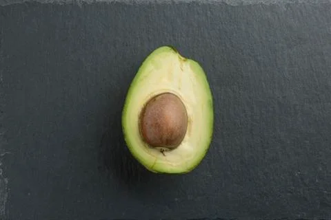 Sliced avocado on a stone background Stock Photos