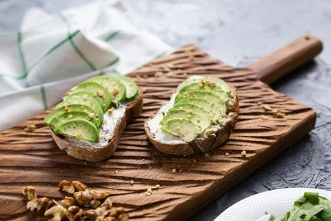 Sliced avocado on toast bread with nuts Stock Photos