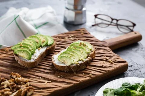 Sliced avocado on toast bread with nuts Stock Photos