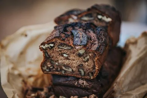 Sliced banana bread with walnuts displayed on crumpled parchment paper, sho.. Stock Photos