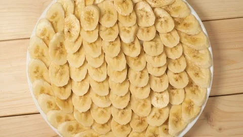 Sliced banana rotating on a plate Stock Footage 340159387