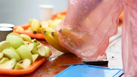 Sliced bananas and apples on the table for runners on refreshment point marathon Stock Footage 97529307