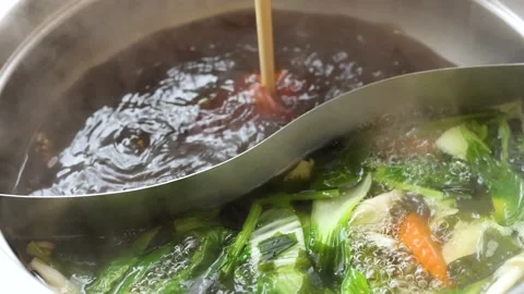 Sliced Beef Cooking in Dual Broth Hotpot with Vegetables Stock Footage 321438347