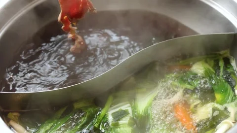 Sliced Beef Cooking in Dual Broth Asian Hotpot Stock Footage 324935269