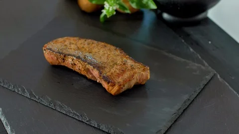 Sliced beef steak with a knife Stock Footage 114076953