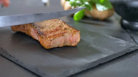 Sliced beef steak with a knife Stock Footage 114080014