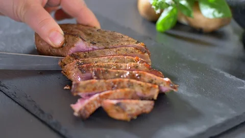 Sliced beef steak with a knife Stock Footage 114080554