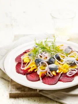 Sliced beetroot served with herring Stock Photos