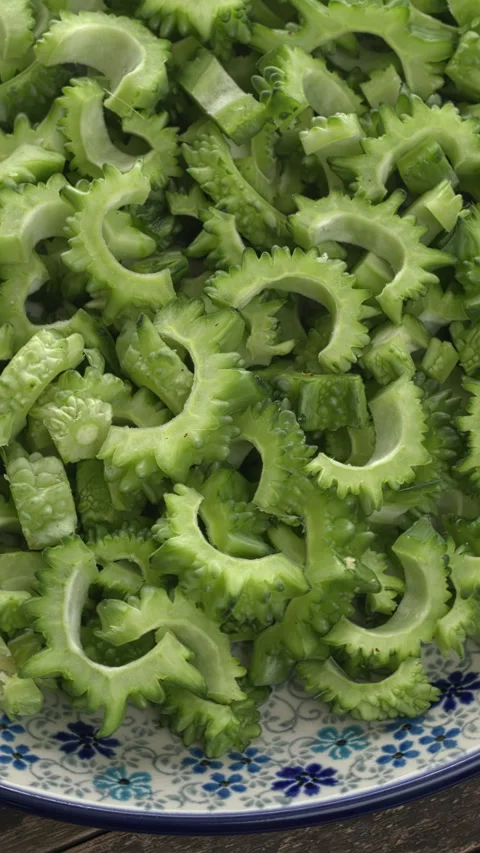 Sliced bitter melon on a plate.  Vertical video. Stock Footage 281176446