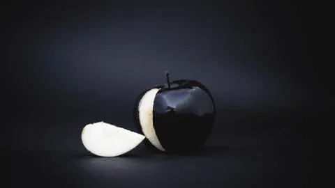 Sliced black apple on a background 写真素材