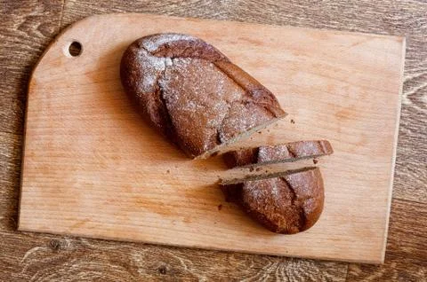 Sliced black bread on board Fotos de archivo