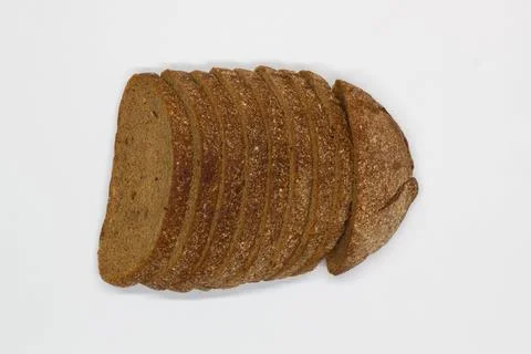 Sliced black bread. Dark rye bread with cumin cut into even pieces on a white Stock Photos