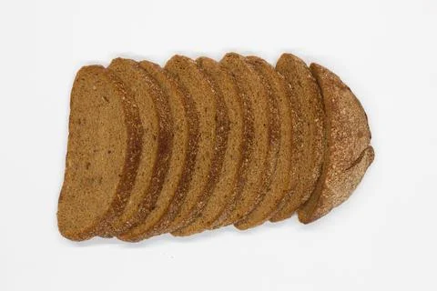 Sliced black bread. Dark rye bread with cumin cut into even pieces on a white Stock Photos
