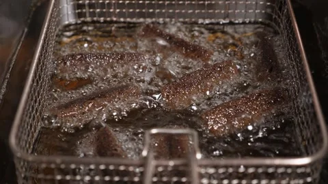 Sliced black bread fried in boiling oil deep-fried in the restaurant kitchen. Stock Footage 260912347