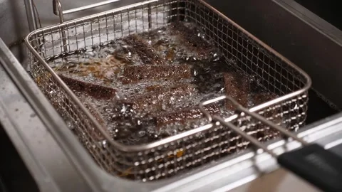 Sliced black bread fried in boiling oil deep-fried in the restaurant kitchen. Stock Footage 261022694