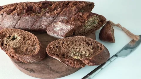 Sliced black garlic bread on a board Stock Footage 196148332