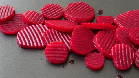 Sliced boiled beetroot on black background Stock Footage 96381794