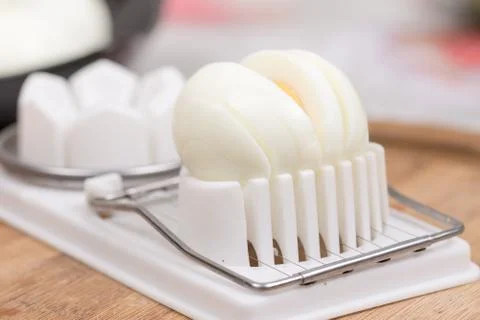 Sliced boiled egg on the cutting machine Stock Photos