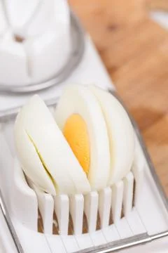 Sliced boiled egg on the cutting machine Stock Photos