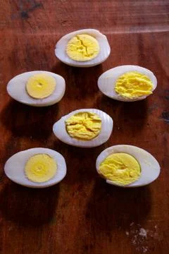 Sliced boiled eggs on the table Stock Photos
