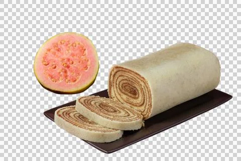 Sliced bolo de rolo on a brown plate, next to a guava (PNG). Stock Photos