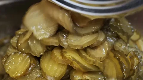 Sliced Bread and Butter Pickles Being Poured or Mixed Stock Footage 331955989