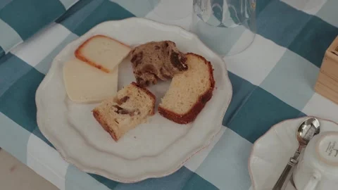 Sliced Bread and Cake Pieces on White Plate Blue Checkered Tablecloth Stock Footage 336197106