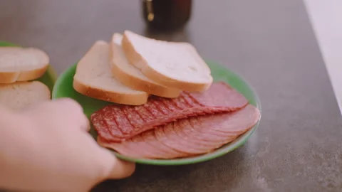 Sliced Bread and Meat on Plate with Coffee in Background Video stock 321423515