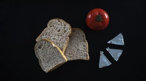 Sliced bread and red tomato with triangle cheese Stock Photos