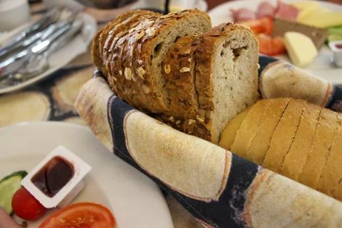 Sliced bread in a basket on the table. Stock Photos