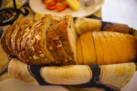 Sliced bread in a basket on the table. Stock Photos