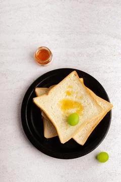 Sliced bread on black plate. Flat lay. Stock Photos