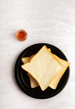Sliced bread on black plate. Flat lay. Stock Photos