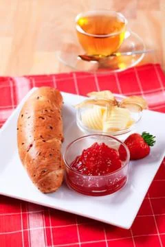 Sliced bread with butter, jam, and chips Stock Photos