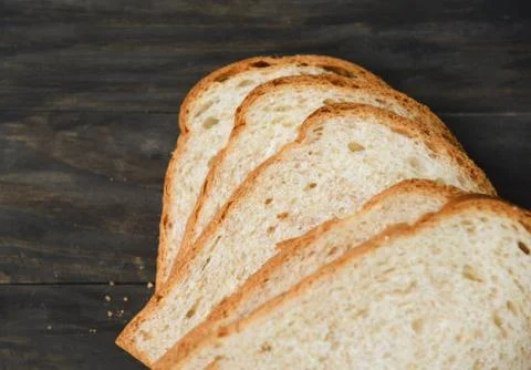 Sliced bread close up top view - Whole wheat bread cut on wooden dark Stock Photos