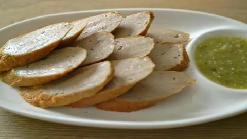 Sliced bread with cucumber and lemon on a white plate Stock Photos