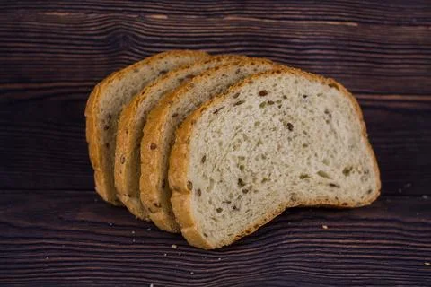 Sliced bread on a dark wood table Stock Photos