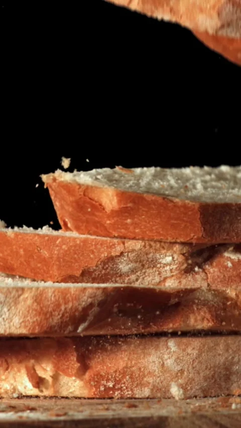 Sliced bread falls onto a cutting board. Filmed on a high-speed camera at 1000 Stock Footage 335364331